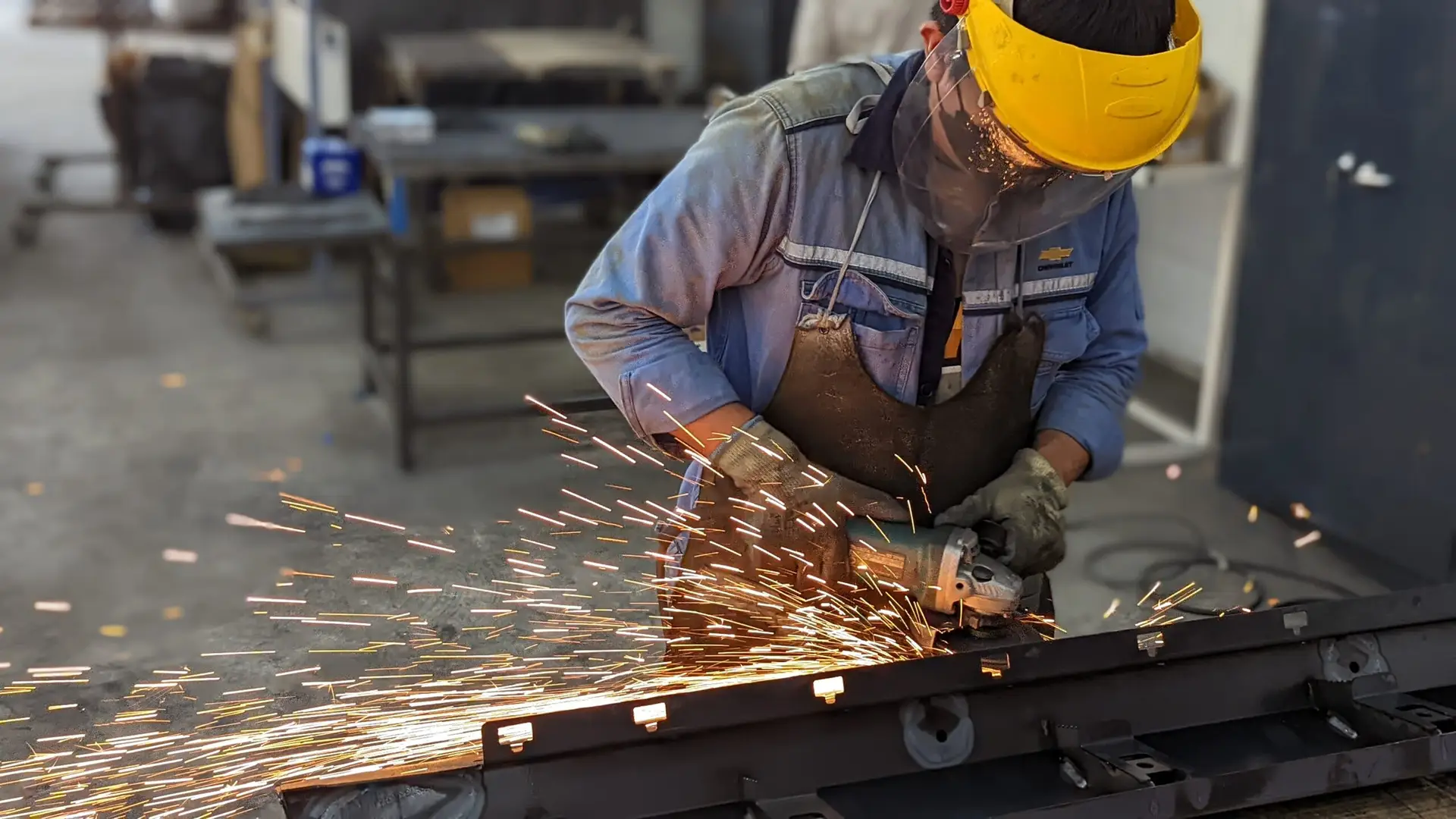 Man grinding with sparks flying off